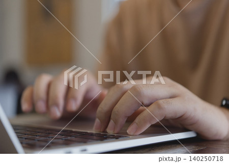 Close up woman hands typing on laptop keyboard. Freelance content creator working online, student studying e-learning, and blogging on social media technology concept at home. 140250718