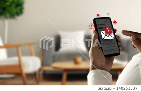 Person holding smartphone with spam warning icons and fake message alert interface, representing SMS phishing attack, mobile scam risk, online fraud prevention, and cyber security protection. Person holding smartphone with spam warning icons and fake message alert interface, representing SMS phishing attack, mobile scam risk, online fraud prevention, and cyber security protection. 140251337