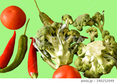 A selection of fresh vegetables, including ripe carrots, cauliflower, red tomatoes and a few hot chili peppers. 140252049