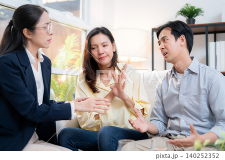 Asian couple arguing with therapist during home consultation. Asian couple arguing with therapist during home consultation. 140252352