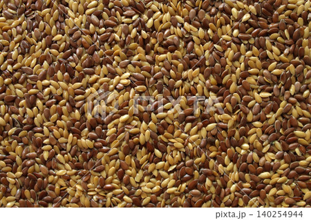 Mixed flax seeds macro texture brown and golden linseed Mixed flax seeds macro texture brown and golden linseed 140254944