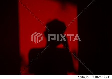 Abstract Red Shadow Silhouette in Dramatic Light Mystery and Emotion Concept Abstract Red Shadow Silhouette in Dramatic Light Mystery and Emotion Concept 140255271