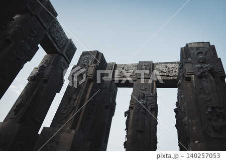 Dramatic Low Angle View of Monumental Stone Gateway with Historical Reliefs 140257053