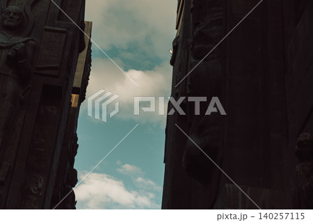 Dramatic Low Angle View of Monumental Stone Gateway with Historical Reliefs 140257115