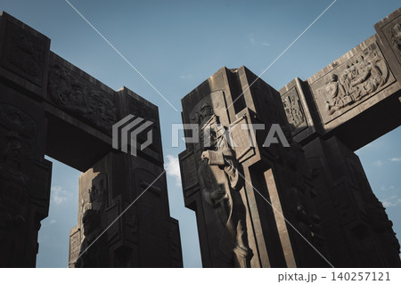 Dramatic Low Angle View of Monumental Stone Gateway with Historical Reliefs Dramatic Low Angle View of Monumental Stone Gateway with Historical Reliefs 140257121
