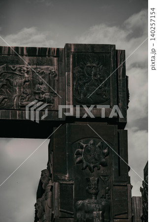 Dramatic Low Angle View of Monumental Stone Gateway with Historical Reliefs 140257154