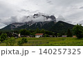 Tyrolean Alpine Village Meadow Below Cloudy Mountain Peaks 140257325