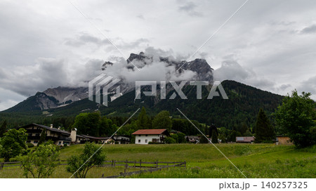 Tyrolean Alpine Village Meadow Below Cloudy Mountain Peaks Tyrolean Alpine Village Meadow Below Cloudy Mountain Peaks 140257325