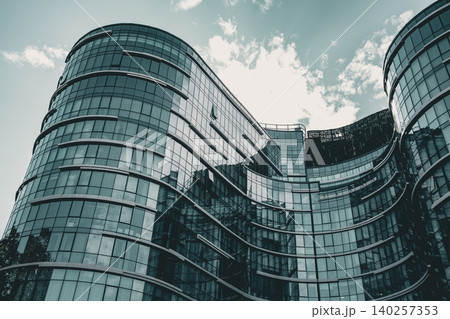 Modern Curved Glass Office Complex with Reflective Facade Modern Curved Glass Office Complex with Reflective Facade 140257353