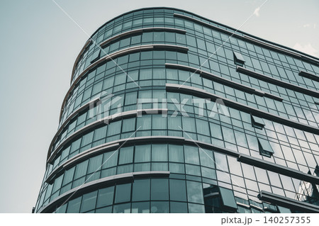 Modern Curved Glass Office Complex with Reflective Facade Modern Curved Glass Office Complex with Reflective Facade 140257355