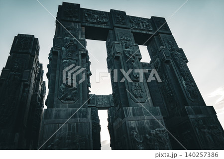 Ancient Monumental Stone Gateway with Historical Relief Sculptures and Cultural Heritage Figures Ancient Monumental Stone Gateway with Historical Relief Sculptures and Cultural Heritage Figures 140257386