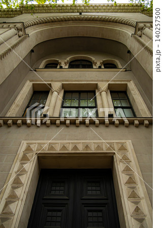 Grand Classical Building Entrance with Ornate Arch, Columns and Decorative Stonework Grand Classical Building Entrance with Ornate Arch, Columns and Decorative Stonework 140257500