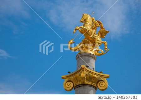 Golden Saint George Monument Slaying Dragon on Decorative Column, Historic Equestrian Sculpture Golden Saint George Monument Slaying Dragon on Decorative Column, Historic Equestrian Sculpture 140257503