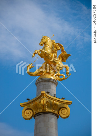 Golden Saint George Monument Slaying Dragon on Decorative Column, Historic Equestrian Sculpture  140257504