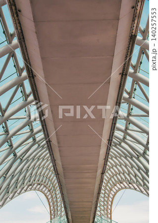 Modern Pedestrian Bridge with Futuristic Steel Structure and Glass Elements 140257553