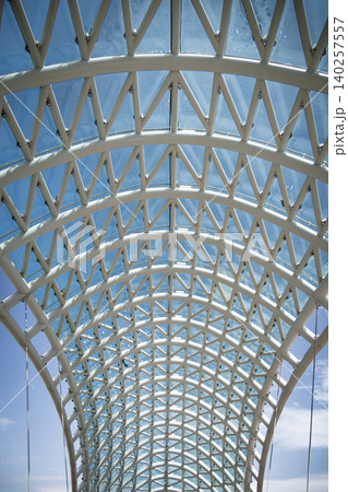Modern Pedestrian Bridge with Futuristic Steel Structure and Glass Elements Modern Pedestrian Bridge with Futuristic Steel Structure and Glass Elements 140257557