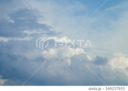 Big fluffy white clouds with the blue sky. Dramatic cloudscape. Nature scene. Nature background. 140257933