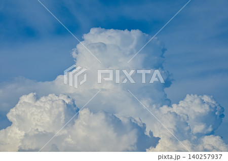 Big fluffy white clouds with the blue sky. Dramatic cloudscape. Nature scene. Nature background. 140257937