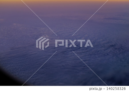 Looking through the airplane window with the sunset sky. Romantic sky, golden hours, colorful sunset sky with clouds. Stunning cloudscape and skyscape. Nature concept. For background use. 140258326