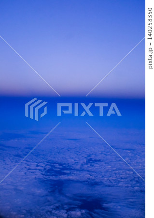 Looking through the airplane window with the sunset sky. Romantic sky, golden hours, colorful sunset sky with clouds. Stunning cloudscape and skyscape. Nature concept. For background use. 140258350