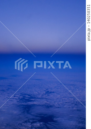 Looking through the airplane window with the sunset sky. Romantic sky, golden hours, colorful sunset sky with clouds. Stunning cloudscape and skyscape. Nature concept. For background use. 140258351