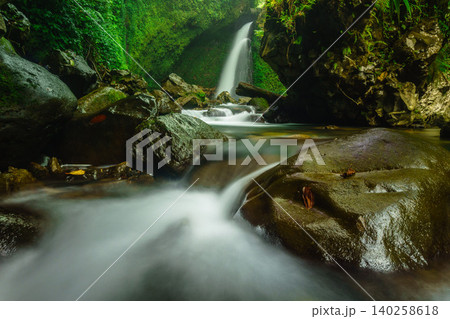 Aerial view of a hidden waterfall deep within the lush tropical rainforest of Mount Daun Aerial view of a hidden waterfall deep within the lush tropical rainforest of Mount Daun 140258618