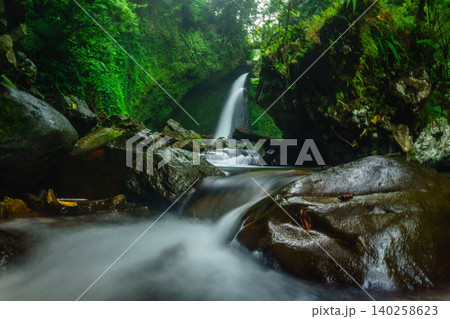 Aerial view of a hidden waterfall deep within the lush tropical rainforest of Mount Daun 140258623