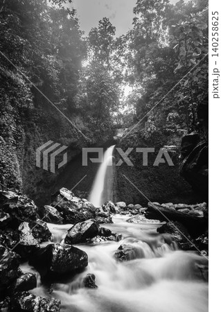 Aerial view of a hidden waterfall deep within the lush tropical rainforest of Mount Daun Aerial view of a hidden waterfall deep within the lush tropical rainforest of Mount Daun 140258625