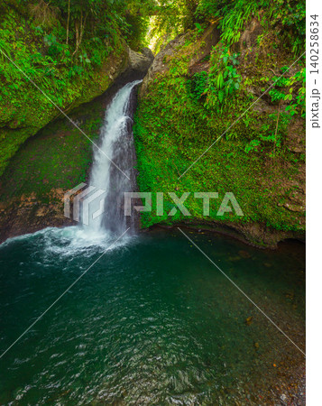 Aerial view of a hidden waterfall deep within the lush tropical rainforest of Mount Daun 140258634