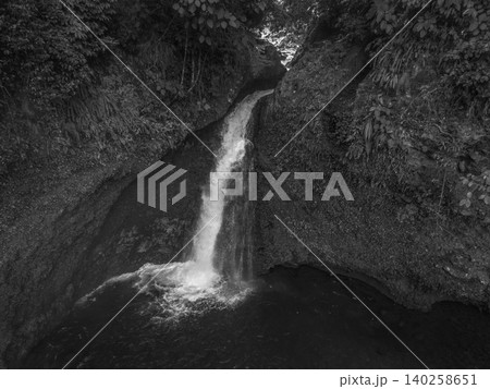 Aerial view of a hidden waterfall deep within the lush tropical rainforest of Mount Daun 140258651