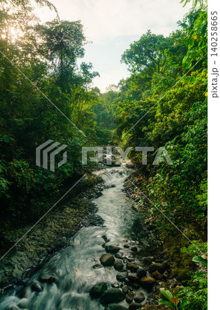 Aerial view of a hidden waterfall deep within the lush tropical rainforest of Mount Daun Aerial view of a hidden waterfall deep within the lush tropical rainforest of Mount Daun 140258665
