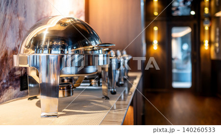 Closed round chafing dish or buffet warmer in dining area of luxury hotel Closed round chafing dish or buffet warmer in dining area of luxury hotel 140260533
