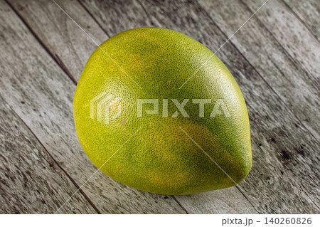 Green Pomelo Fruit on Rustic Wooden Surface 140260826