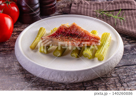 Grilled red mullet fillet on celery stalks with fresh tomatoes and rosemary Grilled red mullet fillet on celery stalks with fresh tomatoes and rosemary 140260886