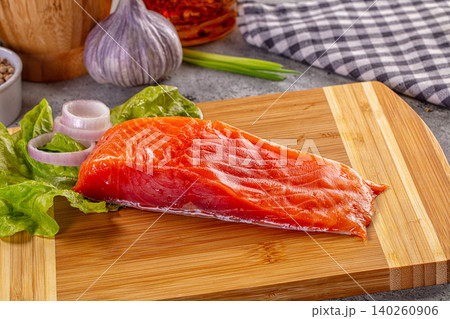 Fresh salmon fillet on wooden cutting board with vegetables Fresh salmon fillet on wooden cutting board with vegetables 140260906