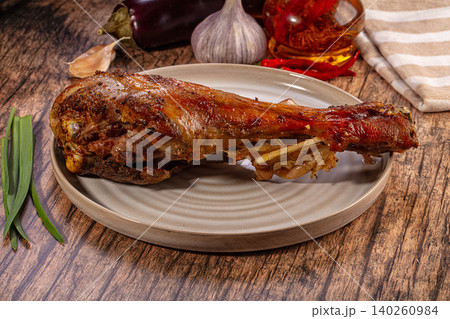 Roasted turkey leg on ceramic plate with vegetables and spices 140260984