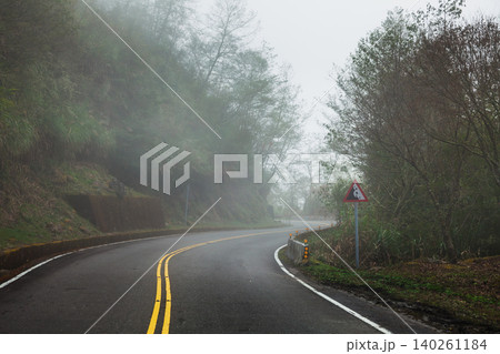 Foggy Mountain Curve With Warning Sign Foggy Mountain Curve With Warning Sign 140261184