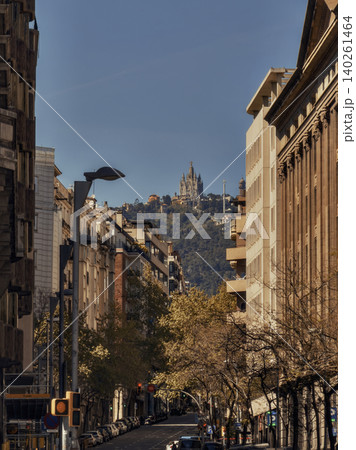 Urban street framed by historic buildings with hillside landmark in the distance Urban street framed by historic buildings with hillside landmark in the distance 140261464