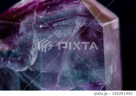 Macro mineral stone Fluorite crystal on a black background Macro mineral stone Fluorite crystal on a black background 140261492