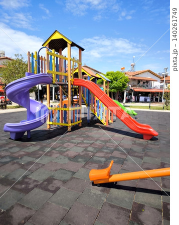 A bright, empty playground with slides beneath a blue sky 140261749