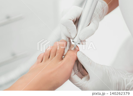 female legs close-up during a hardware manicure female legs close-up during a hardware manicure 140262379