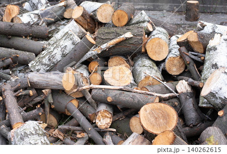 A pile of firewood. Background with firewood. Preparing for winter. Stacking firewood. A pile of firewood. Background with firewood. Preparing for winter. Stacking firewood. 140262615