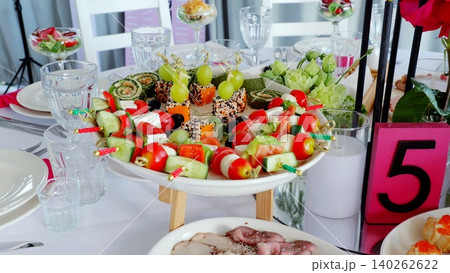Elegant catering banquet table displaying gourmet appetizers, prepared for wedding celebration with professional culinary presentation 140262622