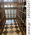 Historic Vintage Elevator Interior with Wooden Frames and Checkered Floor - Art Deco Architecture 140262647