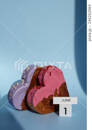 Children's day 1 June wooden calendar cubes wishes greeting holiday card Heartshaped pastry croissant treat topped with colorful frosting galore. Food experimentation viral dessert baking trend 140262664