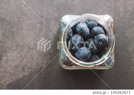 Fresh Blueberries in Glass Jar Top View on Dark Background Fresh Blueberries in Glass Jar Top View on Dark Background 140262671