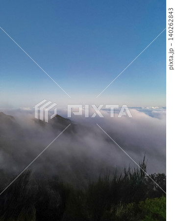 Peak emerging from a sea of clouds on Vereda do Pico Ruivo trail in Madeira Portugal 140262843