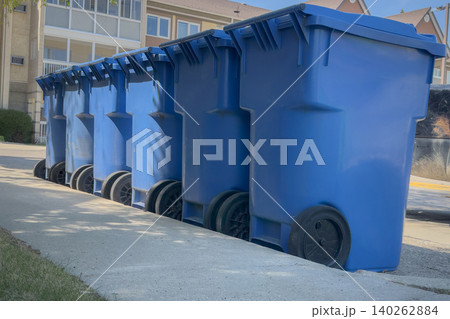 Blue Recycling Bins Lined Along Curb Blue Recycling Bins Lined Along Curb 140262884