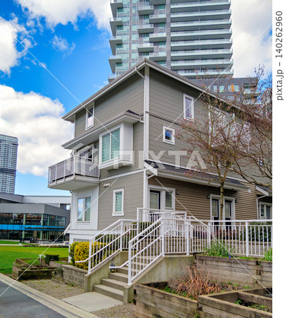 Modern Residential Townhouse and Urban High-Rise Background on a Sunny Day Modern Residential Townhouse and Urban High-Rise Background on a Sunny Day 140262960