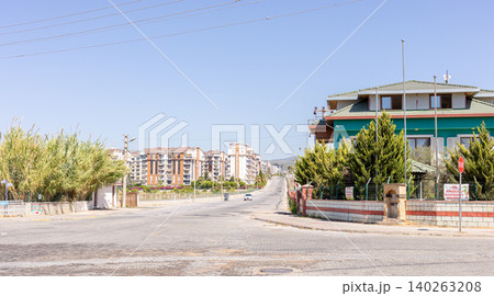 Urban Avsallar street view with residential buildings and greenery in background Urban Avsallar street view with residential buildings and greenery in background 140263208